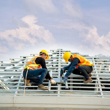 two strong roofer doing his service