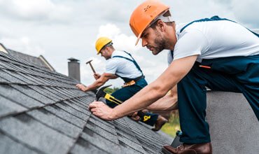 two strong roofer doing his work