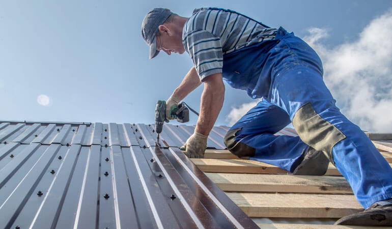 roofer fit metal sheet on roof